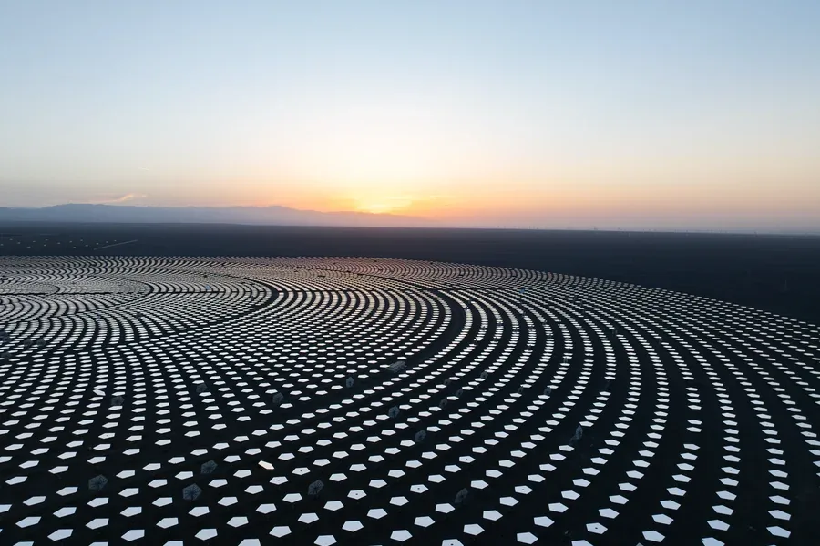 Aerial view of a circular solar farm at sunset representing interconnected open banking systems